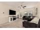 Spacious living room with a sectional sofa and fireplace at 36060 W Santa Clara Ave, Maricopa, AZ 85138