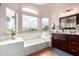 Relaxing bathroom with soaking tub and large window at 3664 E Juanita Ave, Gilbert, AZ 85234