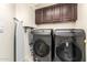 Laundry room with washer, dryer, and cabinets at 3664 E Juanita Ave, Gilbert, AZ 85234