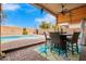 Enjoy meals outdoors in this shaded patio with dining table and chairs at 3664 E Juanita Ave, Gilbert, AZ 85234