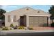 One-story home with neutral exterior, two-car garage, and landscaping at 3811 S 87Th Dr, Tolleson, AZ 85353