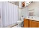 Neat bathroom with shower/tub, wood vanity, and white tile at 4202 S 76Th Ln, Phoenix, AZ 85043