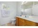 Clean bathroom with single sink vanity, shower/tub combo, and wood cabinets at 4202 S 76Th Ln, Phoenix, AZ 85043