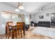 Dining area with wooden table and chairs, adjacent to living room at 4202 S 76Th Ln, Phoenix, AZ 85043