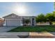 Single-story home with gray exterior, attached garage, and landscaped lawn at 4202 S 76Th Ln, Phoenix, AZ 85043