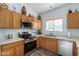 Modern kitchen with stainless steel appliances and wood cabinetry at 4202 S 76Th Ln, Phoenix, AZ 85043