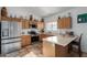 Well-equipped kitchen featuring wood cabinets and stainless steel appliances at 4202 S 76Th Ln, Phoenix, AZ 85043