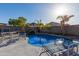 Inviting kidney-shaped pool with patio furniture and waterfall feature at 4202 S 76Th Ln, Phoenix, AZ 85043