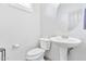 Clean and bright bathroom with pedestal sink and toilet at 4364 E Turnberry Ct, Gilbert, AZ 85298