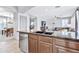 Kitchen with island, stainless steel dishwasher, and view into living room at 4364 E Turnberry Ct, Gilbert, AZ 85298