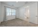 Simple bedroom with large window and carpet flooring at 4641 S Glacier St, Mesa, AZ 85212