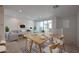 Light and airy dining area with wood table and gray couch at 4641 S Glacier St, Mesa, AZ 85212