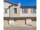 Tan two-story townhome with attached garage and purple shutters at 4641 S Glacier St, Mesa, AZ 85212