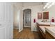 Bathroom featuring double sinks, a walk-in shower, and wood floors at 4644 W Soft Wind Dr, Glendale, AZ 85310