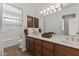 Double vanity bathroom with a large mirror and plenty of storage at 4644 W Soft Wind Dr, Glendale, AZ 85310