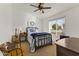 Bright bedroom featuring a metal bed frame and guitar at 4644 W Soft Wind Dr, Glendale, AZ 85310