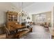 Formal dining room with a rustic wooden table and chandelier at 4644 W Soft Wind Dr, Glendale, AZ 85310