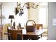 Rustic farmhouse dining room with wooden table and chandelier at 4644 W Soft Wind Dr, Glendale, AZ 85310