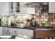 Kitchen detail showing cooktop, granite counters, and tile backsplash at 4644 W Soft Wind Dr, Glendale, AZ 85310