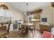 Charming kitchen nook with rustic table and backyard view at 4644 W Soft Wind Dr, Glendale, AZ 85310