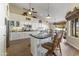 Large kitchen with granite island, white cabinets, and wood floors at 4644 W Soft Wind Dr, Glendale, AZ 85310