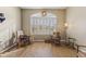 Cozy living room featuring hardwood floors and two antique chairs at 4644 W Soft Wind Dr, Glendale, AZ 85310