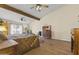 Main bedroom with wood floors, a ceiling fan, and ample natural light at 4644 W Soft Wind Dr, Glendale, AZ 85310