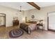 Spacious main bedroom with wood floors and a ceiling fan at 4644 W Soft Wind Dr, Glendale, AZ 85310