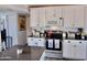 Eat-in kitchen with white cabinets and dark countertops at 5154 N 83Rd St, Scottsdale, AZ 85250