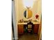 Charming vanity area with a round mirror and wooden cabinets at 5154 N 83Rd St, Scottsdale, AZ 85250