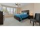 Main bedroom with a king-size bed, nightstands, and ceiling fan at 517 N Cambridge St, Gilbert, AZ 85233