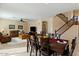 Open concept dining room with seating for six and a view into the living room at 517 N Cambridge St, Gilbert, AZ 85233