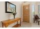 Light and bright entryway with wood console table and mirror at 517 N Cambridge St, Gilbert, AZ 85233