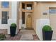 Home entrance with wood door, two planters, and a wreath at 517 N Cambridge St, Gilbert, AZ 85233