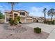 Two-story house with three-car garage and desert landscaping in front at 517 N Cambridge St, Gilbert, AZ 85233