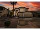 Two-story house with three-car garage, desert landscaping, and a palm tree in the front yard at 517 N Cambridge St, Gilbert, AZ 85233