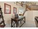 Home office features a dark wood desk, built-in shelving, and view of the staircase at 517 N Cambridge St, Gilbert, AZ 85233