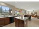 Open kitchen with island, granite countertops and views of the dining and living areas at 517 N Cambridge St, Gilbert, AZ 85233