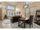 Bright living room with large windows, leather furniture, and a desk at 517 N Cambridge St, Gilbert, AZ 85233