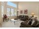 Two story living room with leather sofas and high ceilings at 517 N Cambridge St, Gilbert, AZ 85233