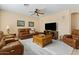 Spacious living room featuring leather furniture, a large TV, and a cozy atmosphere at 517 N Cambridge St, Gilbert, AZ 85233