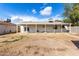 Backyard view showing covered patio and AC unit at 5321 W Country Gables Dr, Glendale, AZ 85306