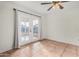 Bedroom with tile floors, french doors and ceiling fan at 5321 W Country Gables Dr, Glendale, AZ 85306