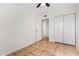 Bedroom with tile floors and double door closet at 5321 W Country Gables Dr, Glendale, AZ 85306