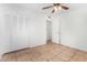 Bedroom with double door closet and ceiling fan at 5321 W Country Gables Dr, Glendale, AZ 85306