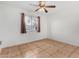 Light and airy bedroom featuring a window and ceiling fan at 5321 W Country Gables Dr, Glendale, AZ 85306