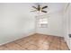 Well-lit bedroom with tile flooring and ceiling fan at 5321 W Country Gables Dr, Glendale, AZ 85306