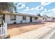 Front view of a single story home with a yard and driveway at 5321 W Country Gables Dr, Glendale, AZ 85306