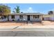 Charming ranch home with a well-maintained front yard and sidewalk at 5321 W Country Gables Dr, Glendale, AZ 85306