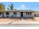 Ranch style home with a landscaped yard and a walkway to the front door at 5321 W Country Gables Dr, Glendale, AZ 85306